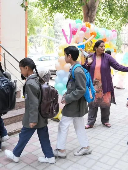 Teachers and volunteers guiding students into the venue, ensuring a smooth and supportive experience for everyone.