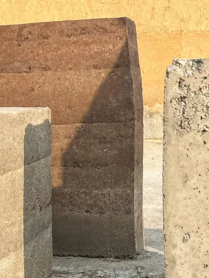 An exploration of rammed earth and concrete as building materials. The distinct layers and textures highlight the natural beauty of earth-based construction, a sustainable technique we employ for projects in sensitive ecological contexts like the hills of Almora.