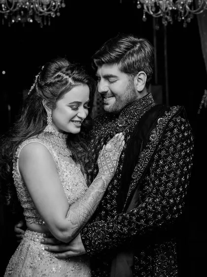 A romantic black and white photo of the couple in a loving embrace. The soft lighting and their happy expressions make this a beautiful, classic portrait from their engagement.