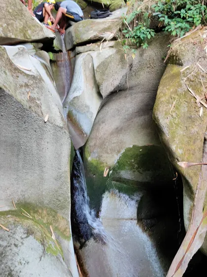 The top of a waterfall in a sandstone canyon, showing the beautiful patterns carved by water over millennia. We teach you to appreciate the geology as much as the adventure.