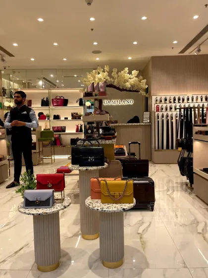 Another interior view focusing on the product pedestals and the cash counter in the background, showcasing the store's elegant and clean design.