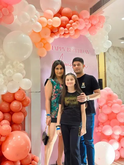 A lovely family portrait in front of the custom balloon arch.