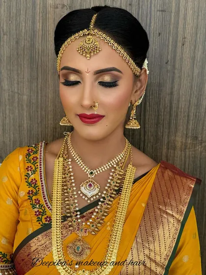A close-up showing the stunning gold eyeshadow and winged liner, a perfect choice for a traditional yet glamorous bridal look.