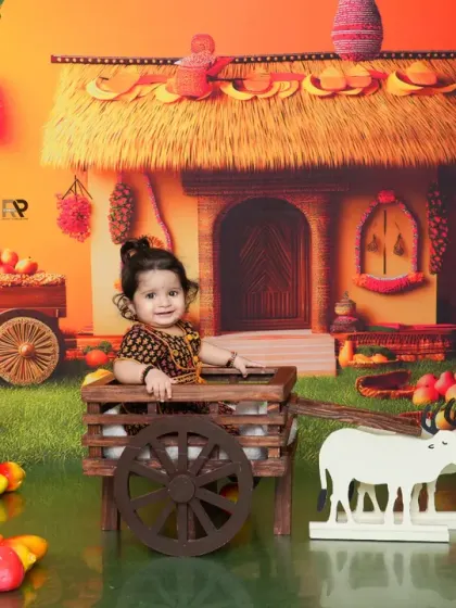 A baby girl in a cute dress sits in a cart in a vibrant, colorful farm setting. The backdrop of a village hut and fresh produce creates a lively and imaginative scene.