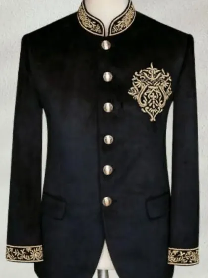 A classic black velvet Jodhpuri jacket with elegant gold embroidery on the collar, chest, and cuffs. This is a luxurious piece for a winter wedding or a formal reception.