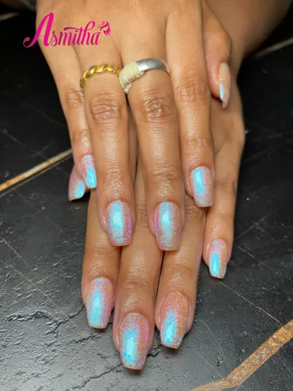 The iridescent pearl finish on these nail extensions looks stunning from every angle, reflecting a spectrum of light for a magical effect.