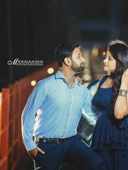 A beautiful nighttime pre-wedding shot on a bridge in Rishikesh. The city lights create a lovely bokeh effect, adding a touch of magic to this romantic portrait.