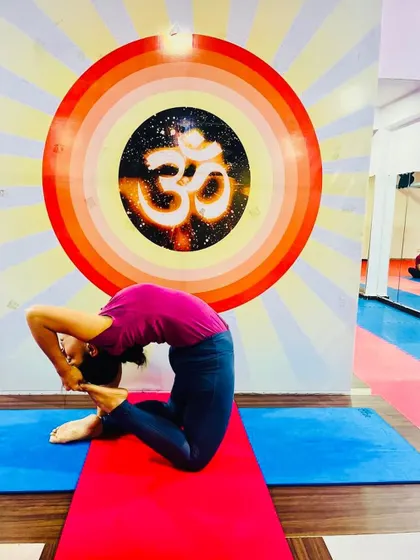 A deep expression of Kapotasana (Pigeon Pose), a challenging backbend that opens the shoulders, chest, and hip flexors.