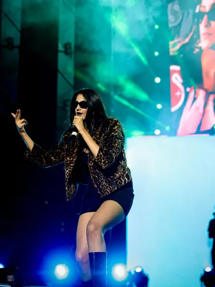 An energetic, full-body shot of Shahat Gill performing. I make sure to capture the artist's entire look and on-stage movement.