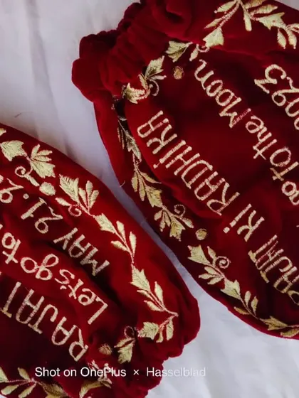 Custom embroidered velvet potli bags for the bride and groom, featuring their names, wedding date, and a fun quote.