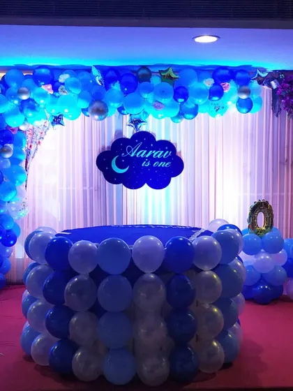 A popular choice for a boy's first birthday is this moon and stars theme. I provide a complete package including the custom name sign, a balloon-covered cake table, and a full backdrop to make the celebration special.