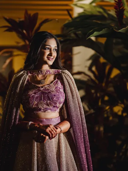 My bride Surabhi looking like a princess for her Sangeeth. Her ombre lehenga with a cape is complemented by soft makeup and loose waves, a perfect look for a night of celebration.