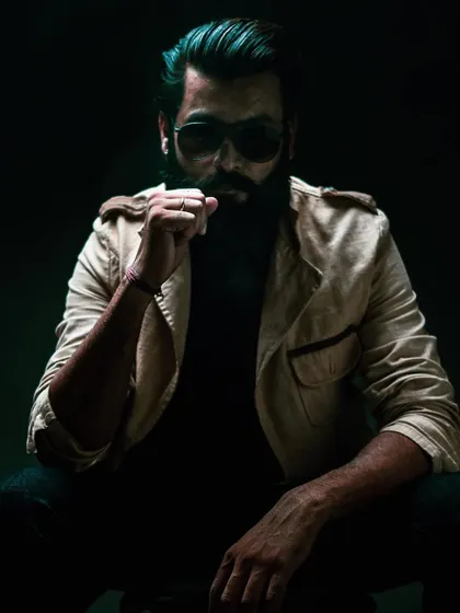 A bold portrait with sunglasses, adding a cool and modern edge to a model's portfolio. The play of light and shadow adds depth to the shot.