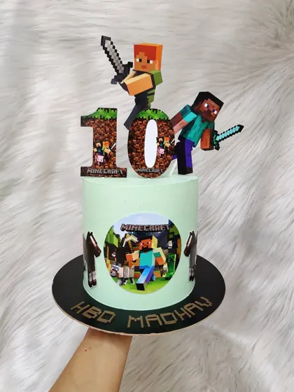 Another great Minecraft cake, this one for a 10th birthday. It features edible images and character toppers of Steve and Alex, ready for an adventure.