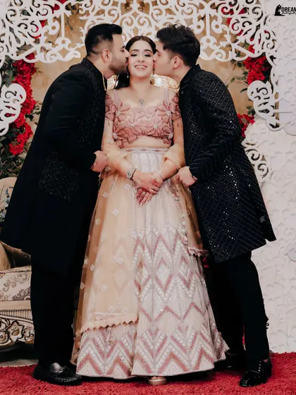 A sweet moment of family love, with the bride Vanshika getting kisses from her brothers at her Roka.
