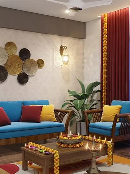 We love creating festive-ready homes. This living room combines traditional Indian elements like a wooden swing and marigold decorations with contemporary blue furniture for a vibrant, welcoming feel.