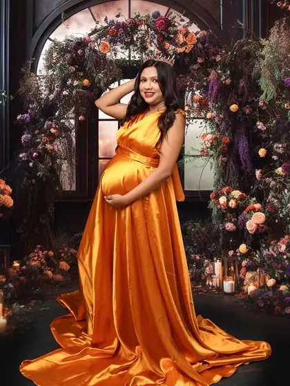 Surrounded by a garden of dreams, this portrait is all about opulence and queenly grace. The rich color of the gown against the elaborate floral backdrop creates a truly breathtaking and regal image.