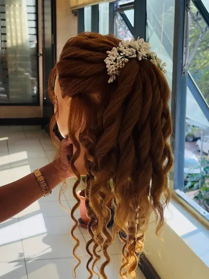 A side profile of the twisted and curled half-updo. This angle highlights the texture and dimension created by the twisting technique.