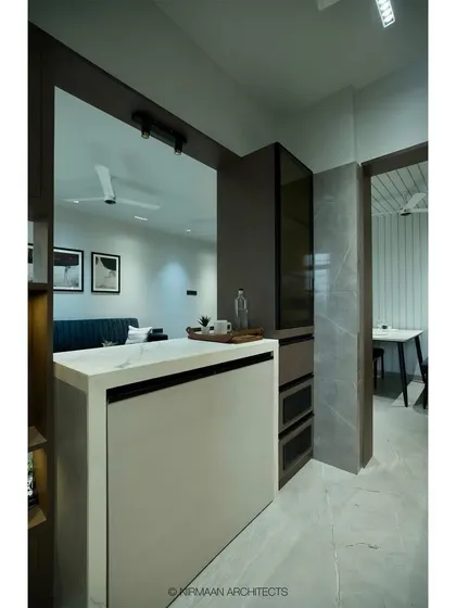 A view from the kitchen side of the breakfast counter at Tulsi Heights, showing how it opens up the space and connects it to the living area.
