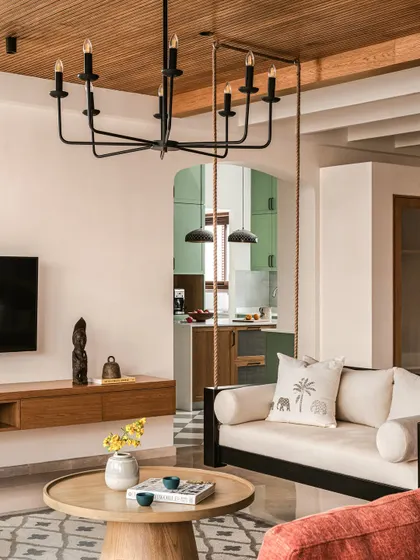 A view from the informal living area peeking into the beautiful sage green kitchen. The open layout creates a great flow between spaces, perfect for family life.