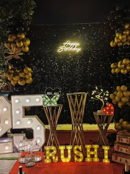 An elegant outdoor 25th birthday celebration by the pool. We used a black sequin wall, gold and black balloons, and marquee lights to create a sophisticated and memorable party atmosphere at night.