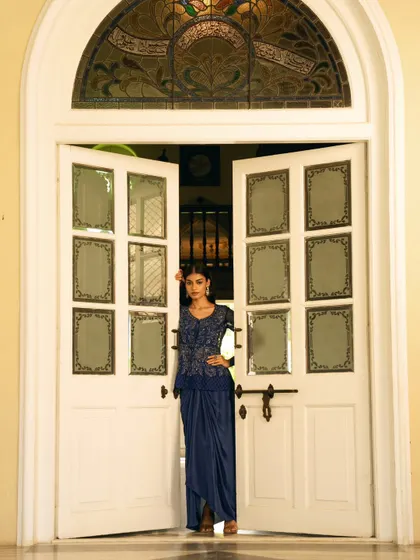 A striking pose in a grand doorway. The composition uses architectural elements to create a powerful and regal portrait.