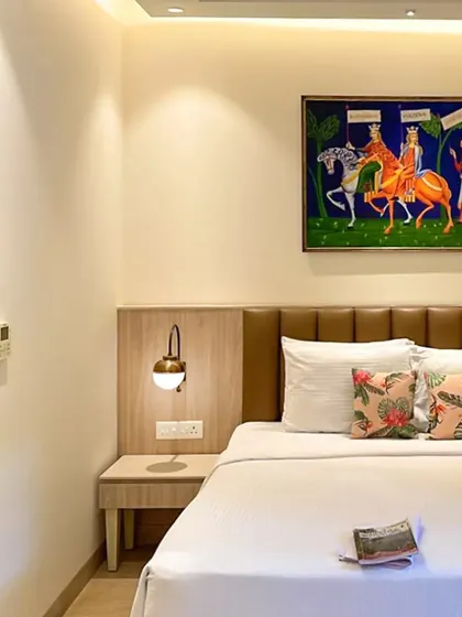 A close-up on the details in the Goa guest room. The custom headboard, integrated side table, and warm reading light are all designed for guest comfort and convenience.