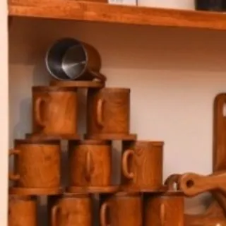 I believe even everyday items should feel special. This stack of handcrafted teak mugs, some lined with steel for durability, shows how the natural warmth and grain of the wood can elevate your daily coffee or tea ritual.