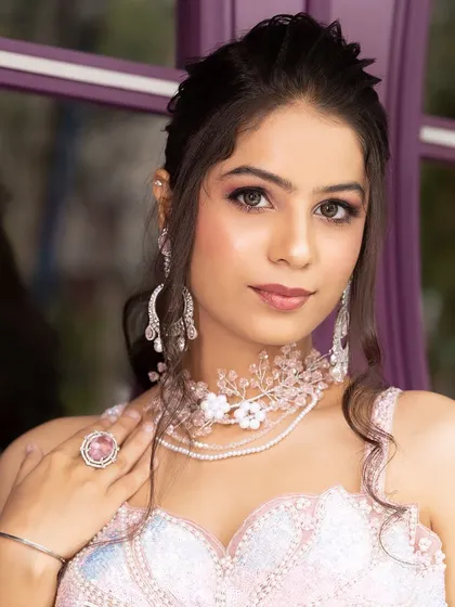 Another angle of the pink floral jewellery, showing how it complements a soft, shimmery makeup look.