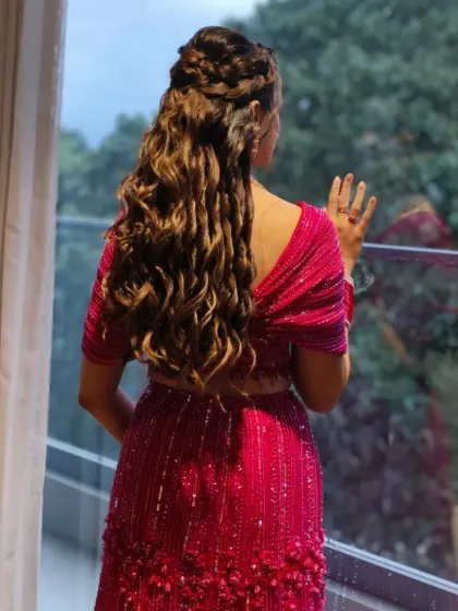 A hairstyle should be a work of art. This intricate combination of braids and soft curls not only looks beautiful from the back but is also designed to stay perfect through a night of dancing.