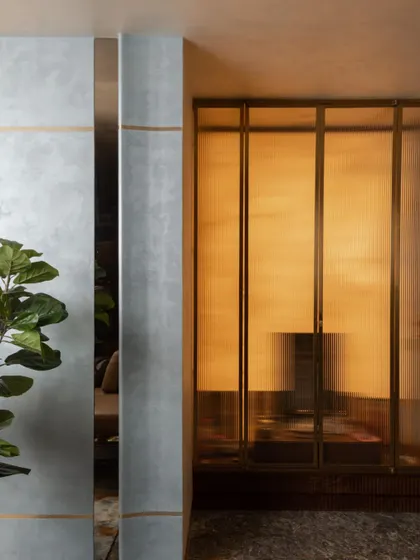 The pooja room, designed as a serene sanctuary. We used fluted glass panels set in delicate metal frames to create a sense of privacy while allowing light to filter through, resulting in a space that feels both sacred and modern.