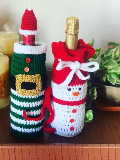 An elf and snowman bottle cover, showcasing the fun character designs I create.