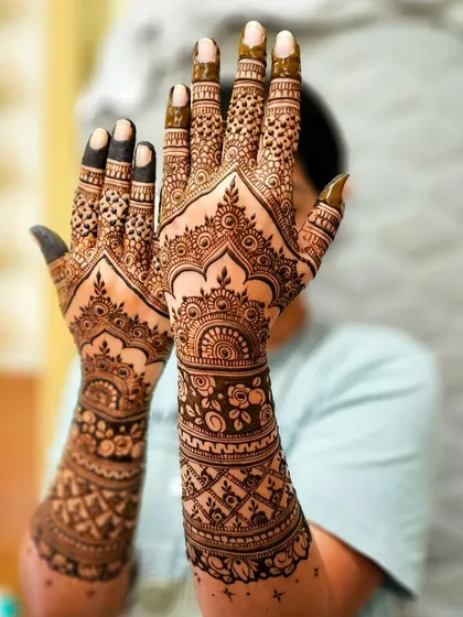 The palms are a canvas for the most detailed work. Here you can see the intricate mandalas and patterns that form the heart of the design.
