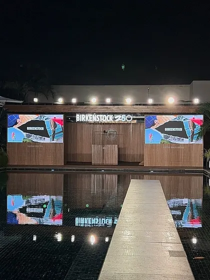 The poolside stage setup for the Birkenstock event at night. Our painting activity was just one part of an incredible evening.