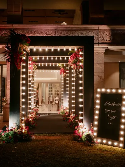 A glamorous entrance for a Sangeet night, framed with marquee lights. This Hollywood inspired entryway immediately sets a festive and celebratory tone.