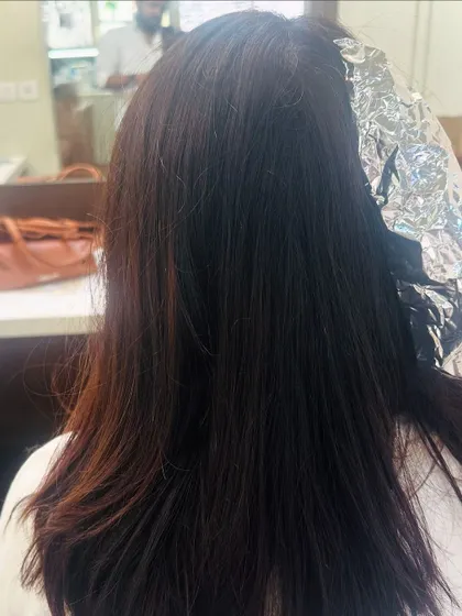 The process of creating a chocolate California brunette look. Here you can see the foils being used to add subtle highlights.
