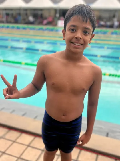 Vihaan G celebrates his Silver Medal in the 100m Freestyle at the State Aquatic Championship. His hard work in training is clearly paying off.
