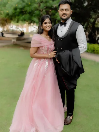 A perfectly coordinated couple. The bride's soft pink gown and the groom's classic tuxedo create an elegant and harmonious look for their engagement photos.