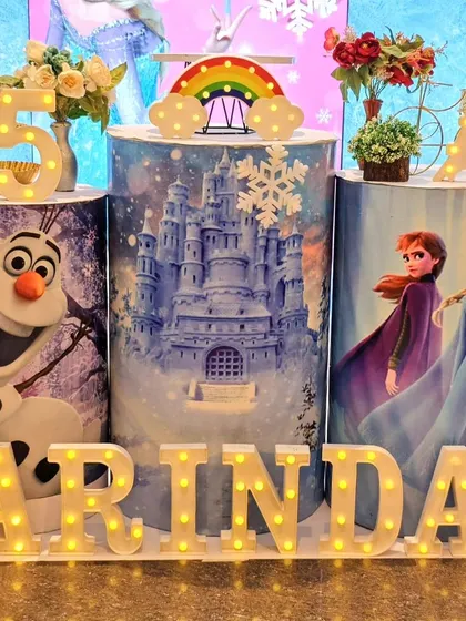Detailed shot of the custom pedestals for a Frozen party, featuring characters and scenes from the movie.