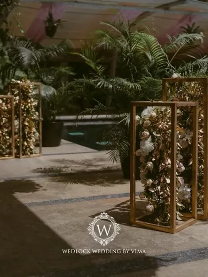 For this Punjabi wedding, we designed a subtle and elegant poolside mandap. The decor featured light fabrics, soft peachy-pink florals, and hints of gold to complement the serene setting.