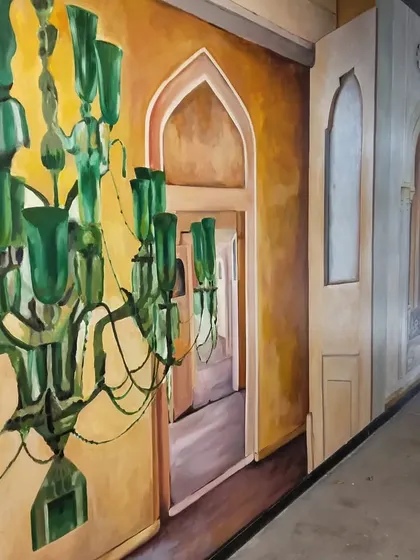 A side view of the Microsoft mural, showing how the painted chandeliers and archways create a continuous visual narrative along the corridor.