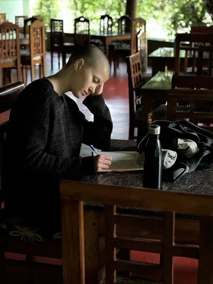 A student takes time for self-reflection and journaling in our dining hall. We encourage these quiet moments to process and comprehend the experiences of the retreat.