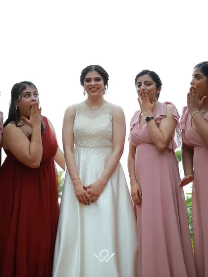 A playful moment with the bride and her bridesmaids, their surprised expressions making for a fun and memorable group photo.