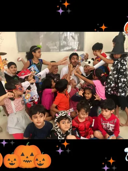 A group photo from a spooktacular Halloween party. The kids are all in costume and having a blast with Professor Antenna.