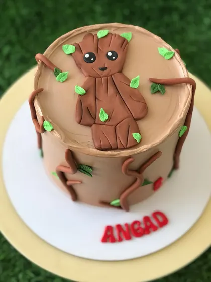 A top-down view of the Baby Groot cake, showing the chocolate "bark" and little green leaves.