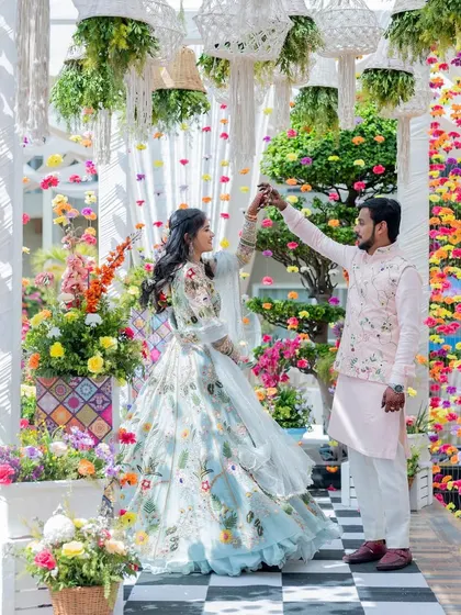 A vibrant and colorful carnival-themed decor, with the couple sharing a dance amidst a sea of flowers.