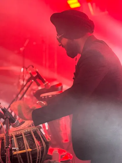 A moody, atmospheric shot of me playing through the stage smoke. It captures the dynamic and mysterious vibe of a live techno fusion set.