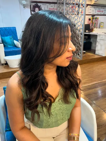 A side view of Tanuja's layered cut.