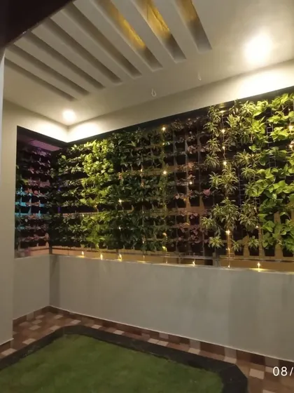 A wider view of the vertical garden installation in a semi-outdoor space. It transforms a plain wall into a living feature, creating a resort-like feel at home.
