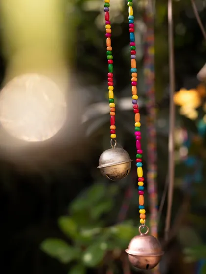 Another detail of the handcrafted hanging bells, showcasing the artistry and soulful charm that these unique, handmade elements bring to a celebration.